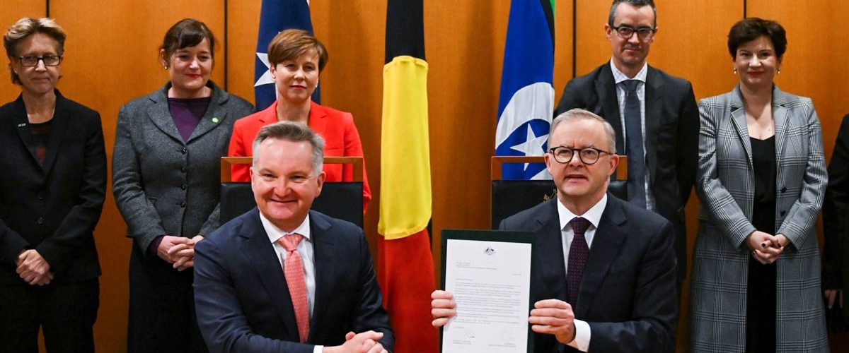 Prime Minister Anthony Albanese and Australian Minister for Climate Change Chris Bowen pose for photographs after signing the Nationally Determined Contribution to a 43% cut in emissions by 2030. (AAP Image/Lukas Coch)