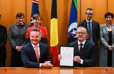 Prime Minister Anthony Albanese and Australian Minister for Climate Change Chris Bowen pose for photographs after signing the Nationally Determined Contribution to a 43% cut in emissions by 2030. (AAP Image/Lukas Coch)